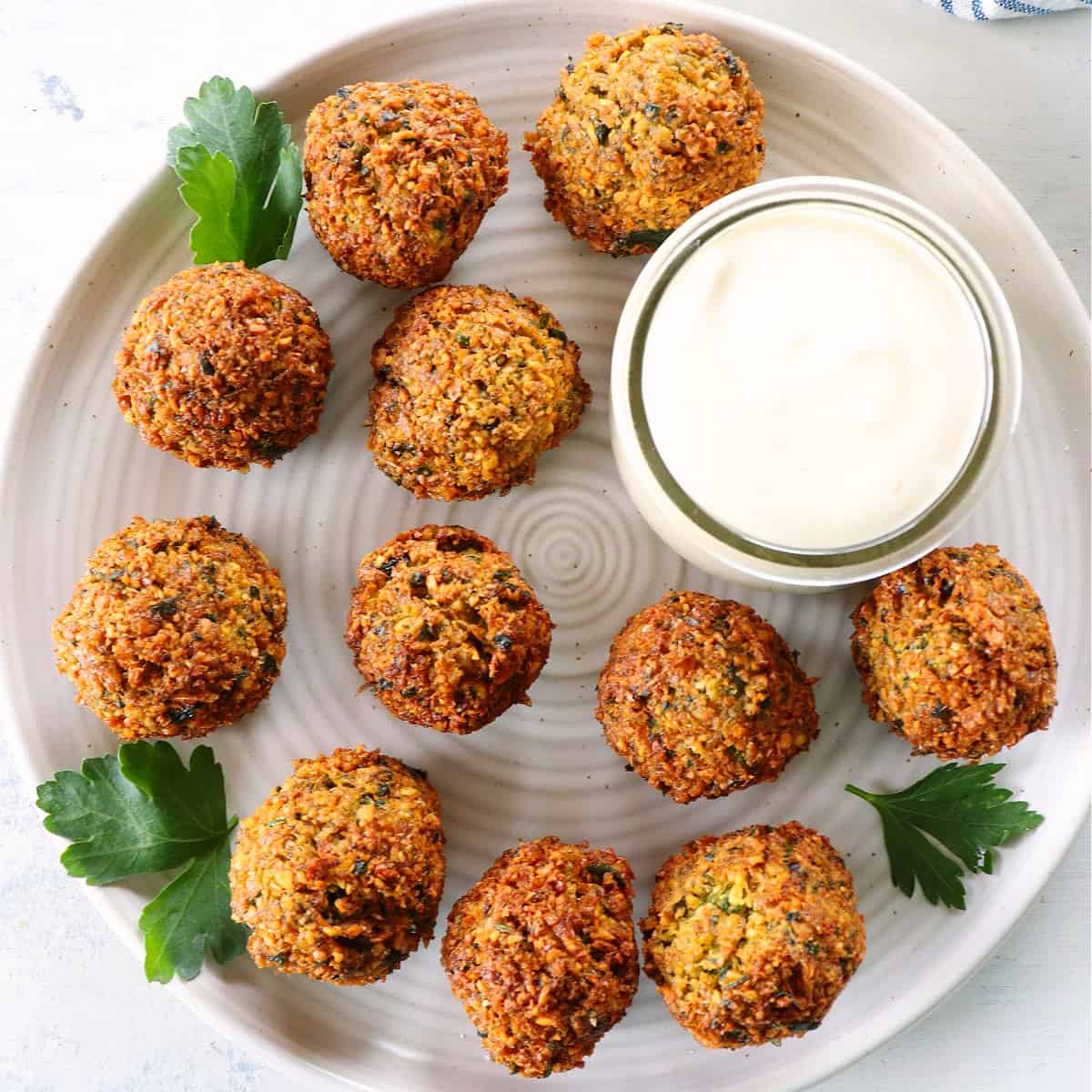 Falafel with sauce on a plate.