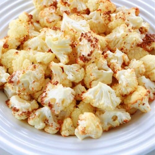 Air fried cauliflower florets on a plate.