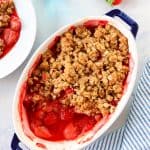 Strawberry crumble in oval baking dish.