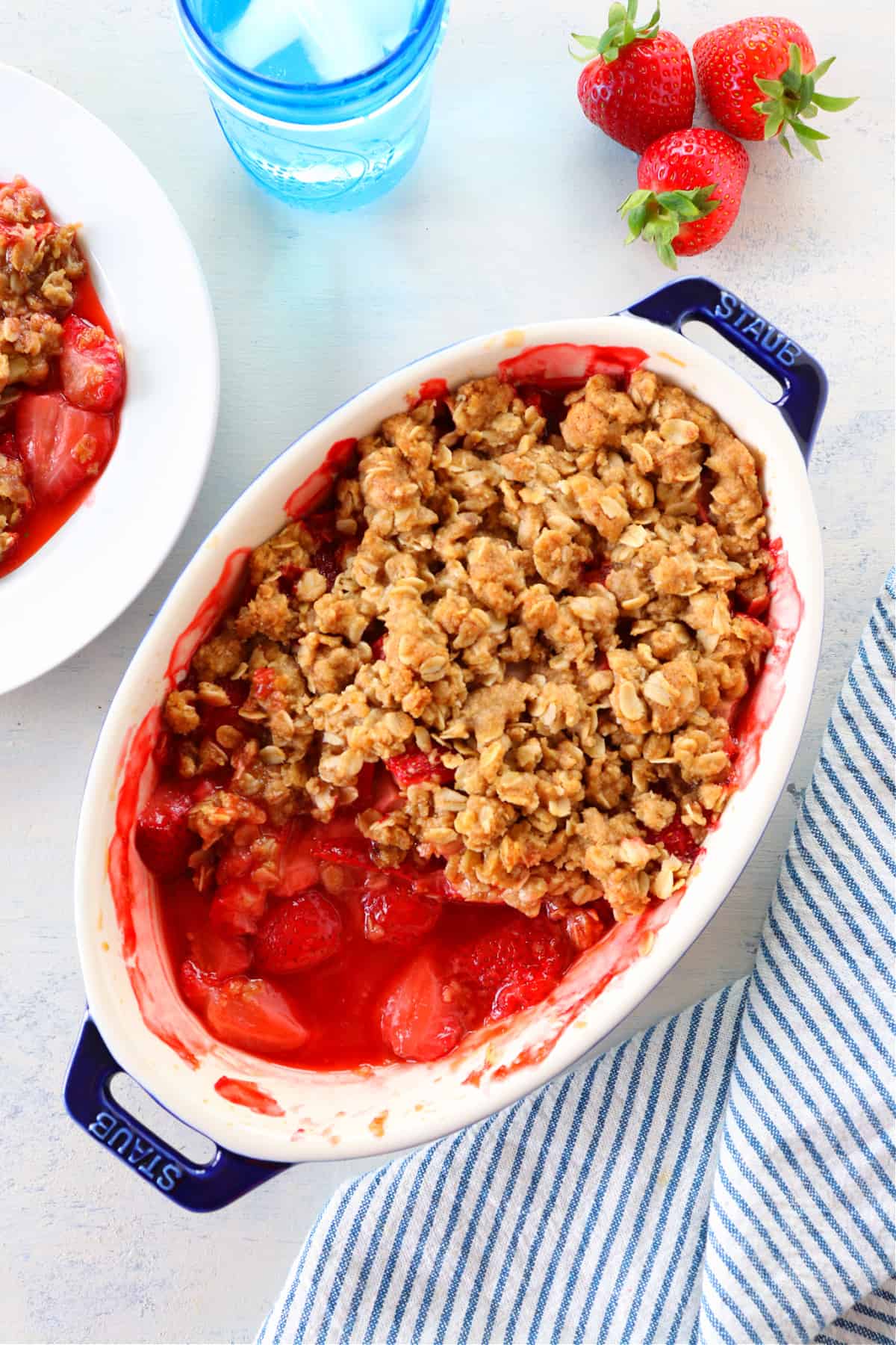 Strawberry crumble in oval baking dish.