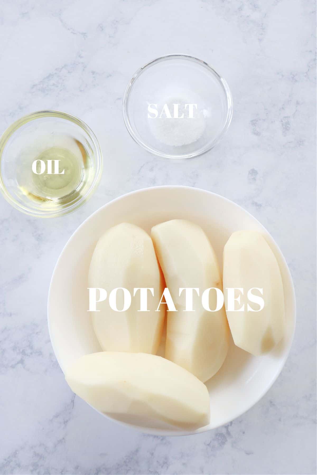 Ingredients for air fryer potato chips on marble board.