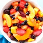 Overhead shot of fruit salad in white bowl.