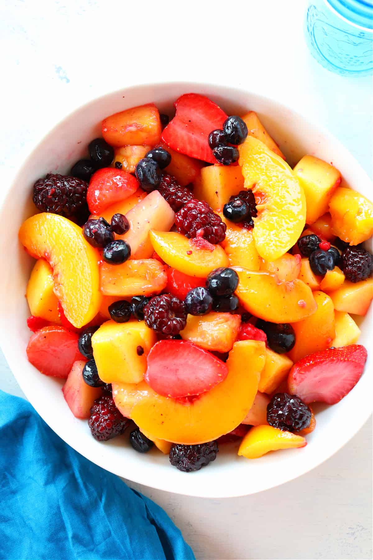 Overhead shot of fruit salad in white bowl.