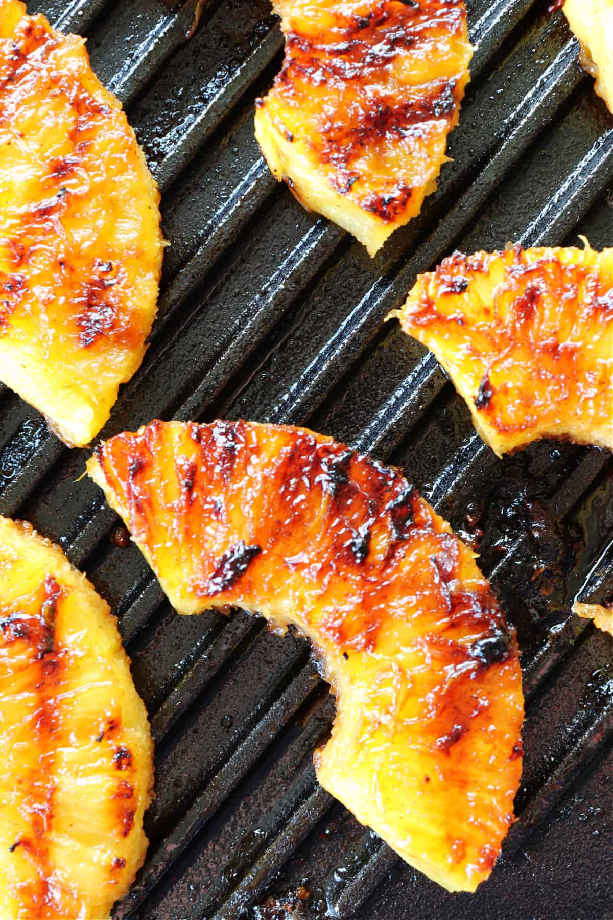 Pineapple slices on a grilling pan.