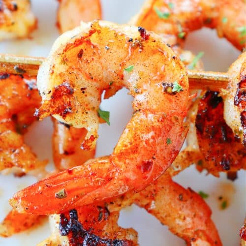 Grilled shrimp skewers on a plate.
