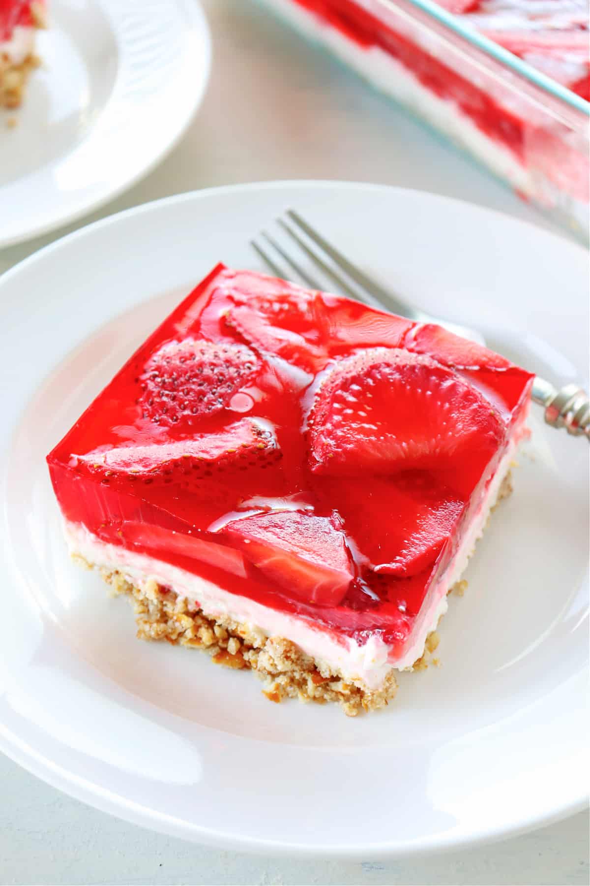 Strawberry pretzel salad serving on a plate.