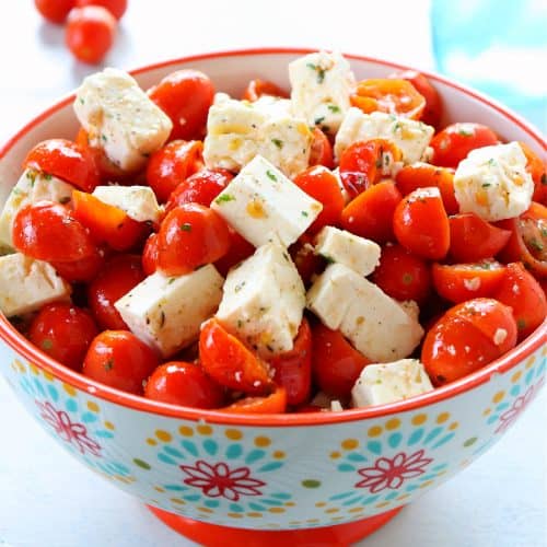 Tomatoes and feta salad in a flower bowl.