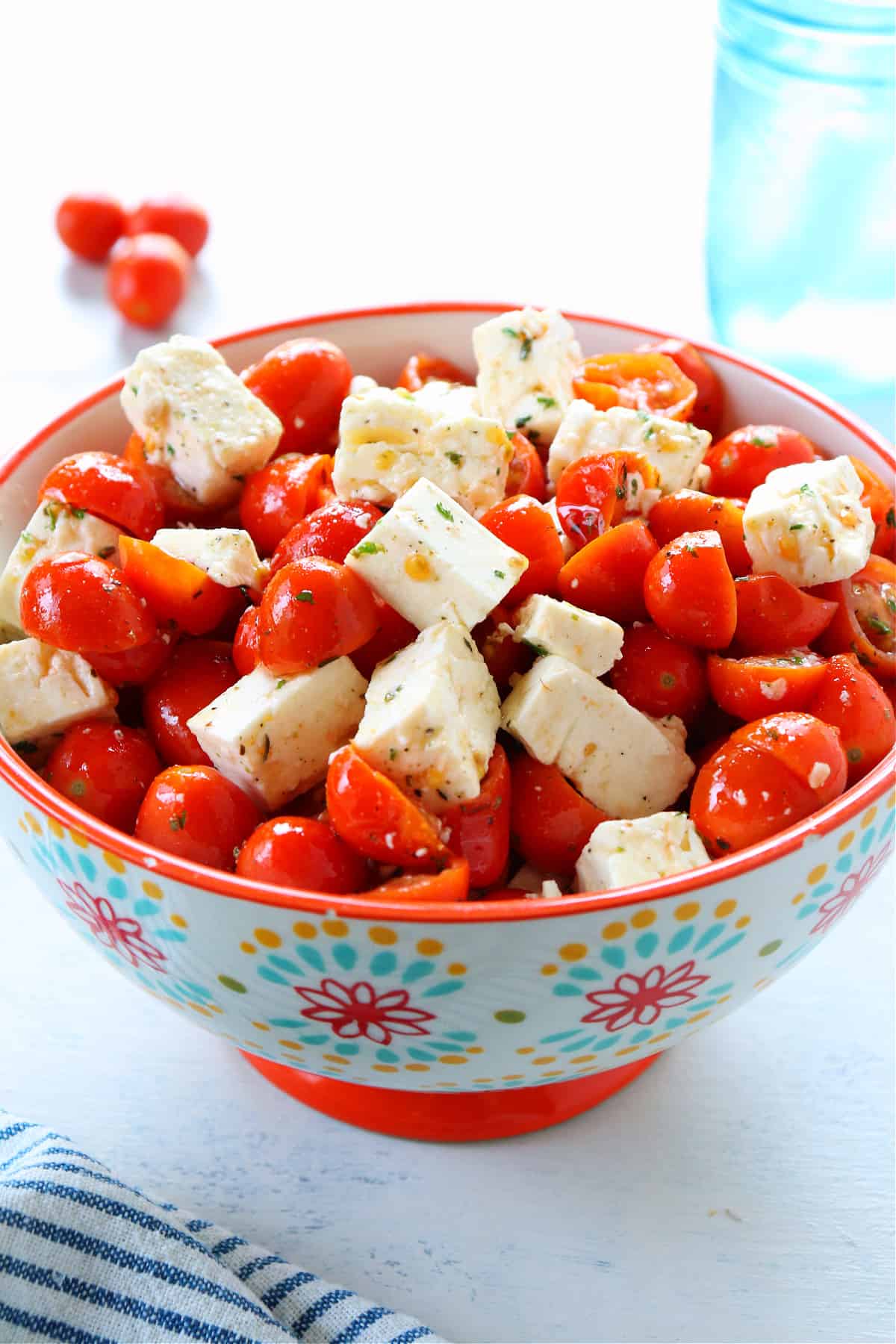 Tomatoes and feta salad in a flower bowl.