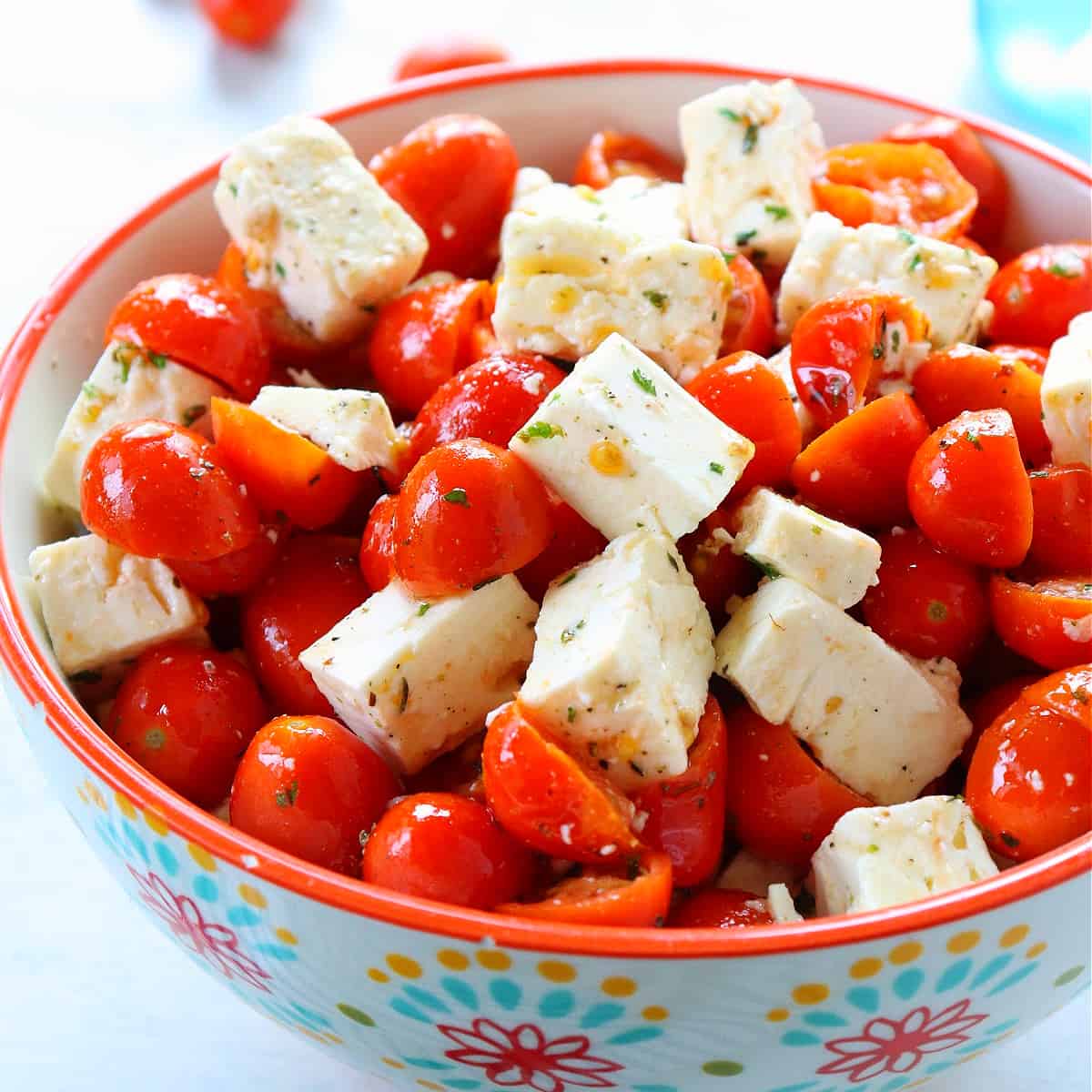 Salad with tomatoes and feta in a bowl.