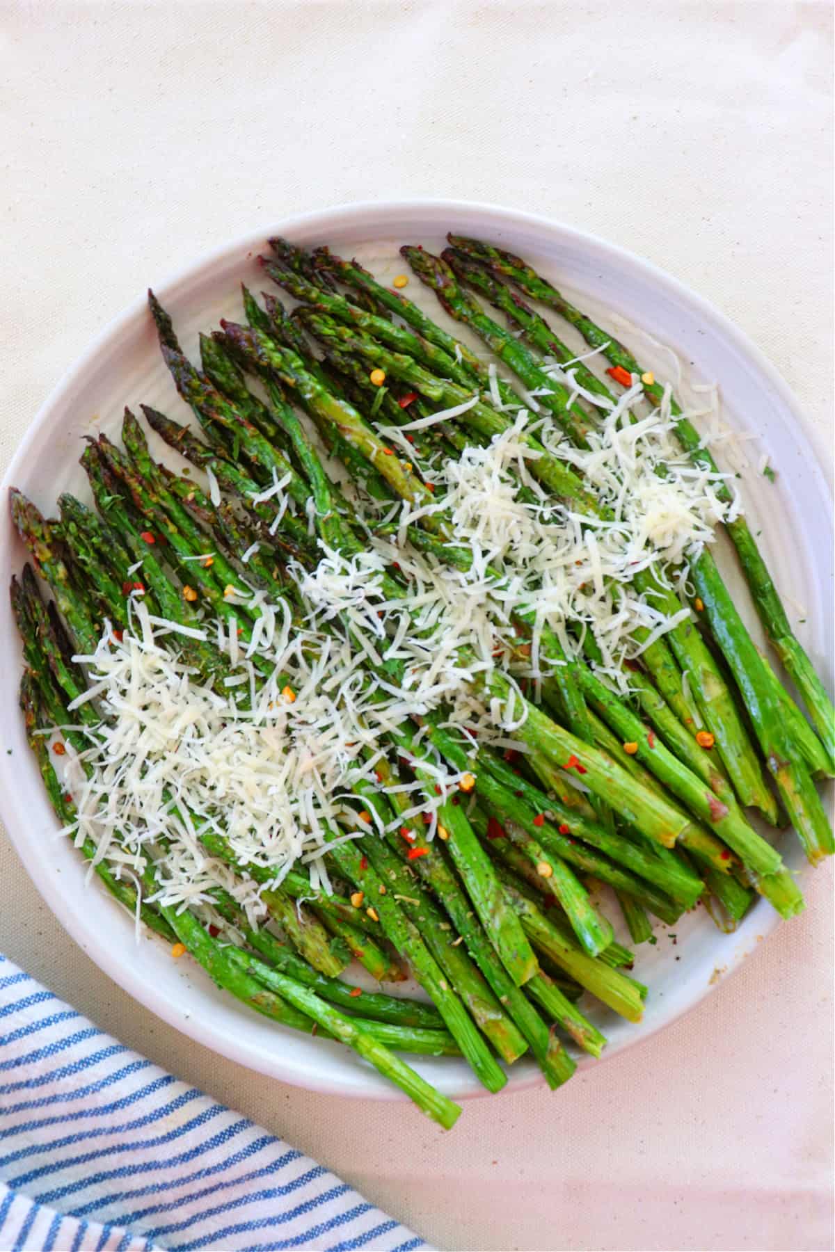 Cooked asparagus with Parmesan cheese topping.