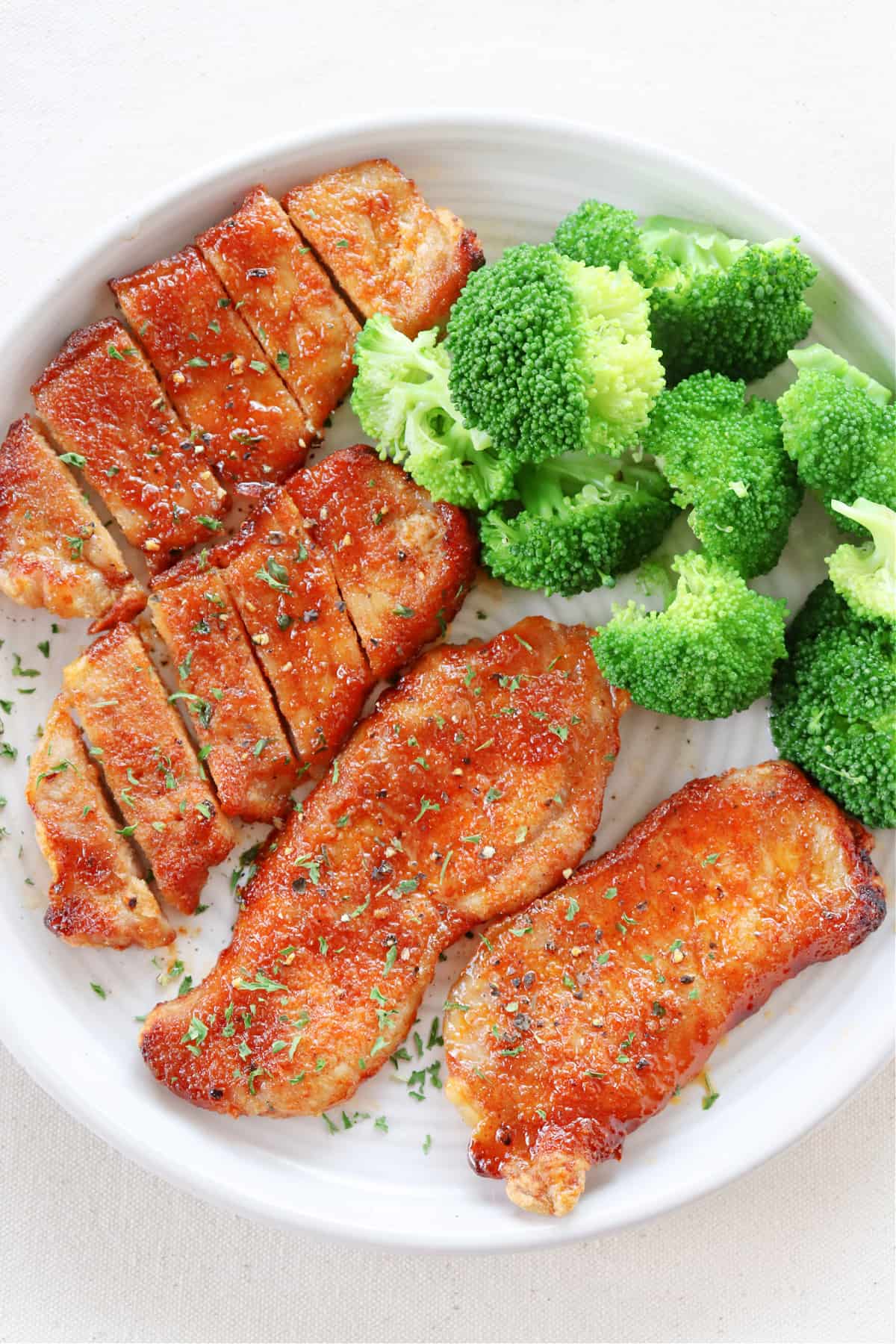 Air Fryer Pork Chops recipe Pork chops and broccoli on a plate.