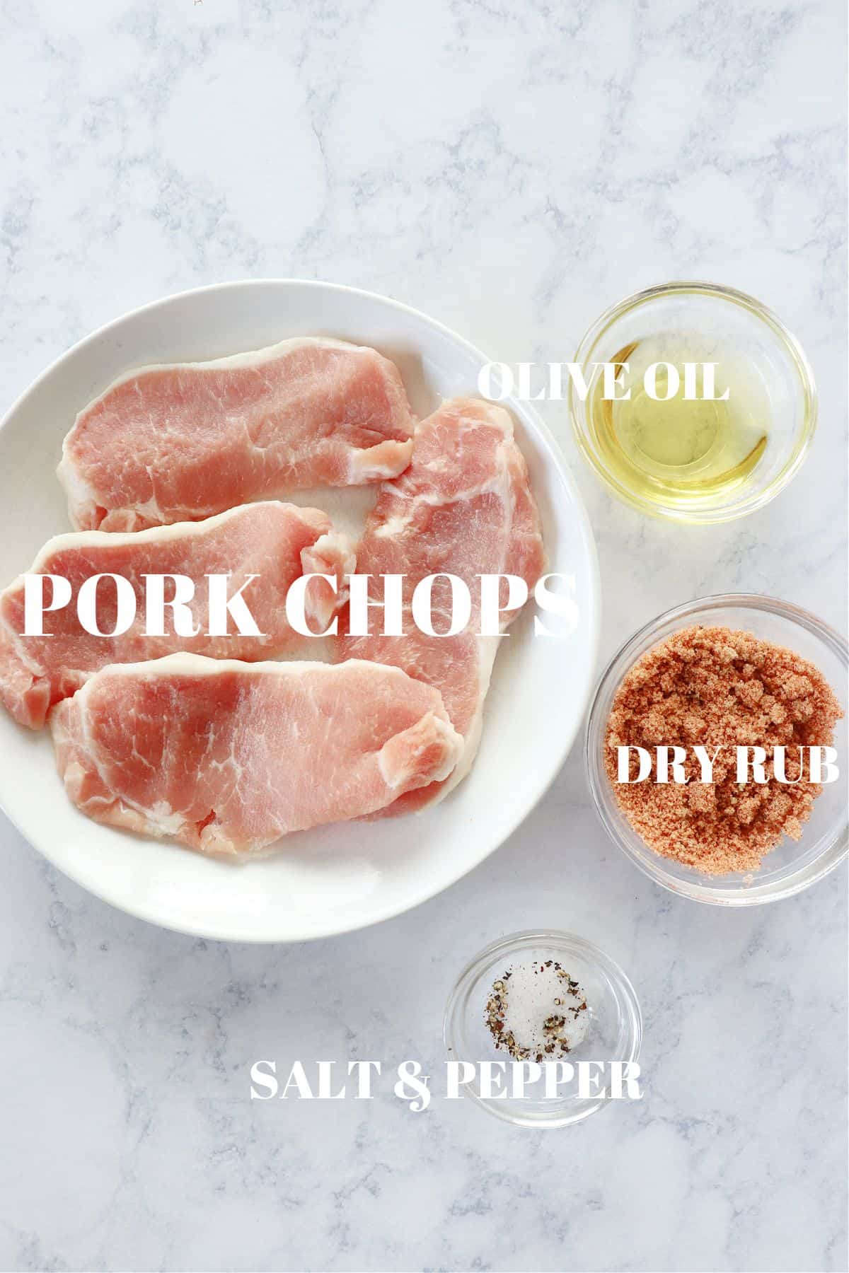 Ingredients for air fryer pork chops on a board.