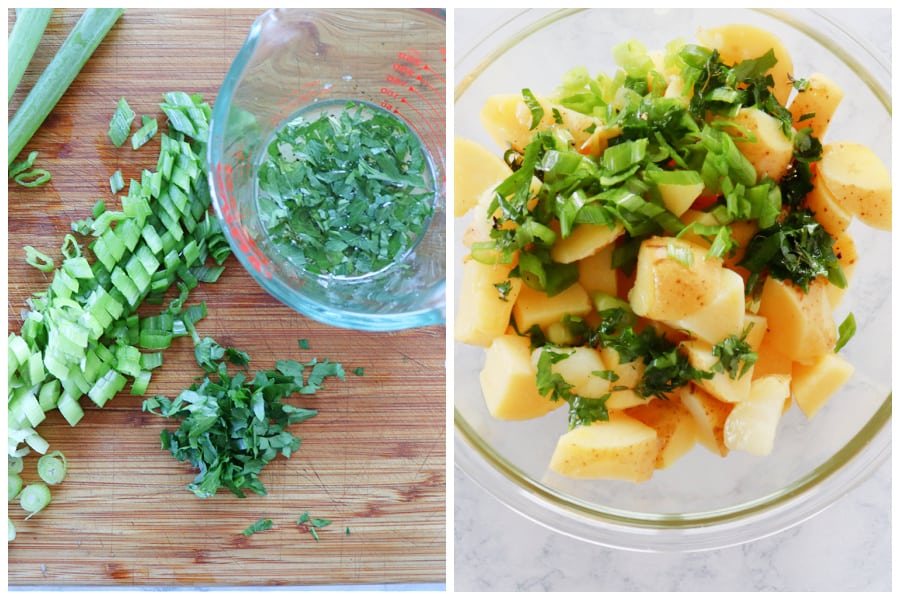 Herbs cut on wooden board and potatoes in a bowl.