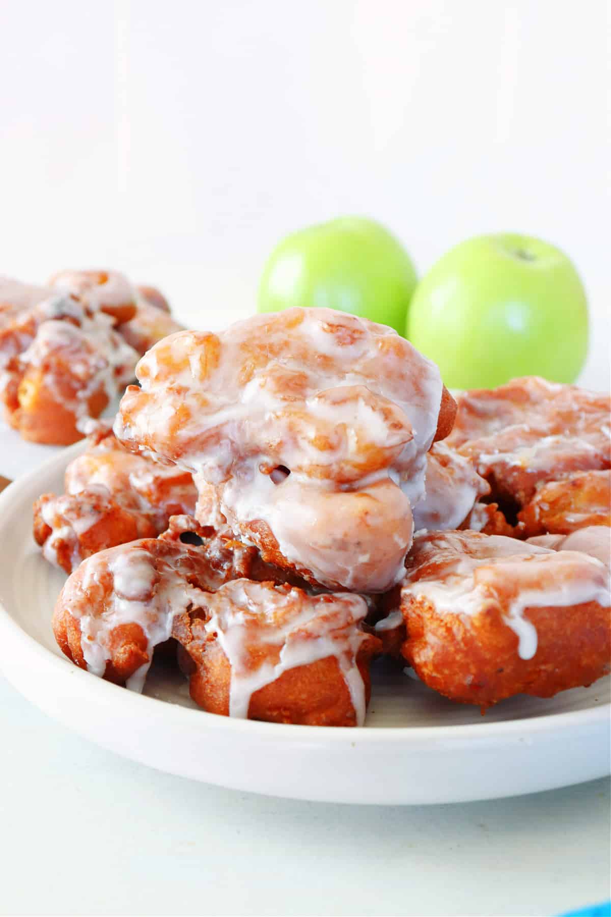 Apple Fritters recipe Apple fritters on a white plate.