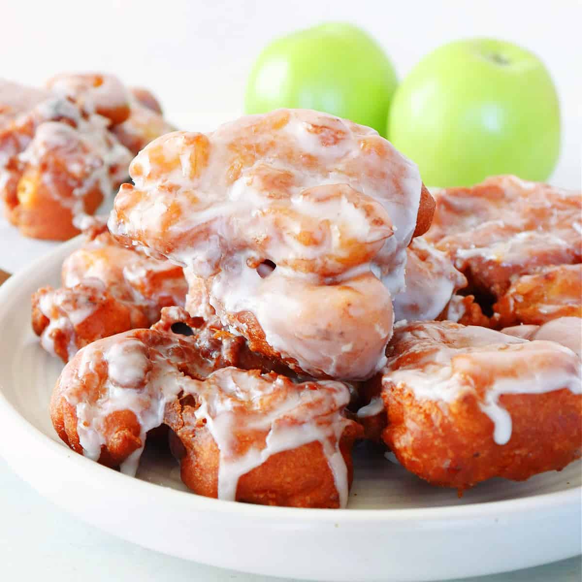 Apple fritters on a white plate.