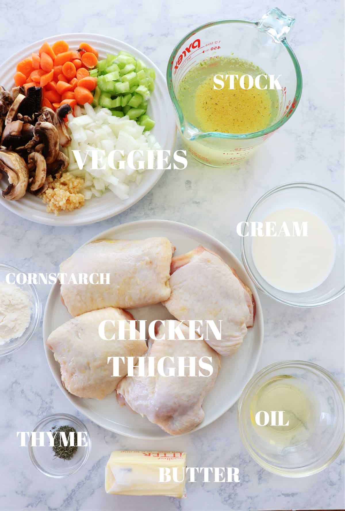 Ingredients for chicken fricassee on a marble board.