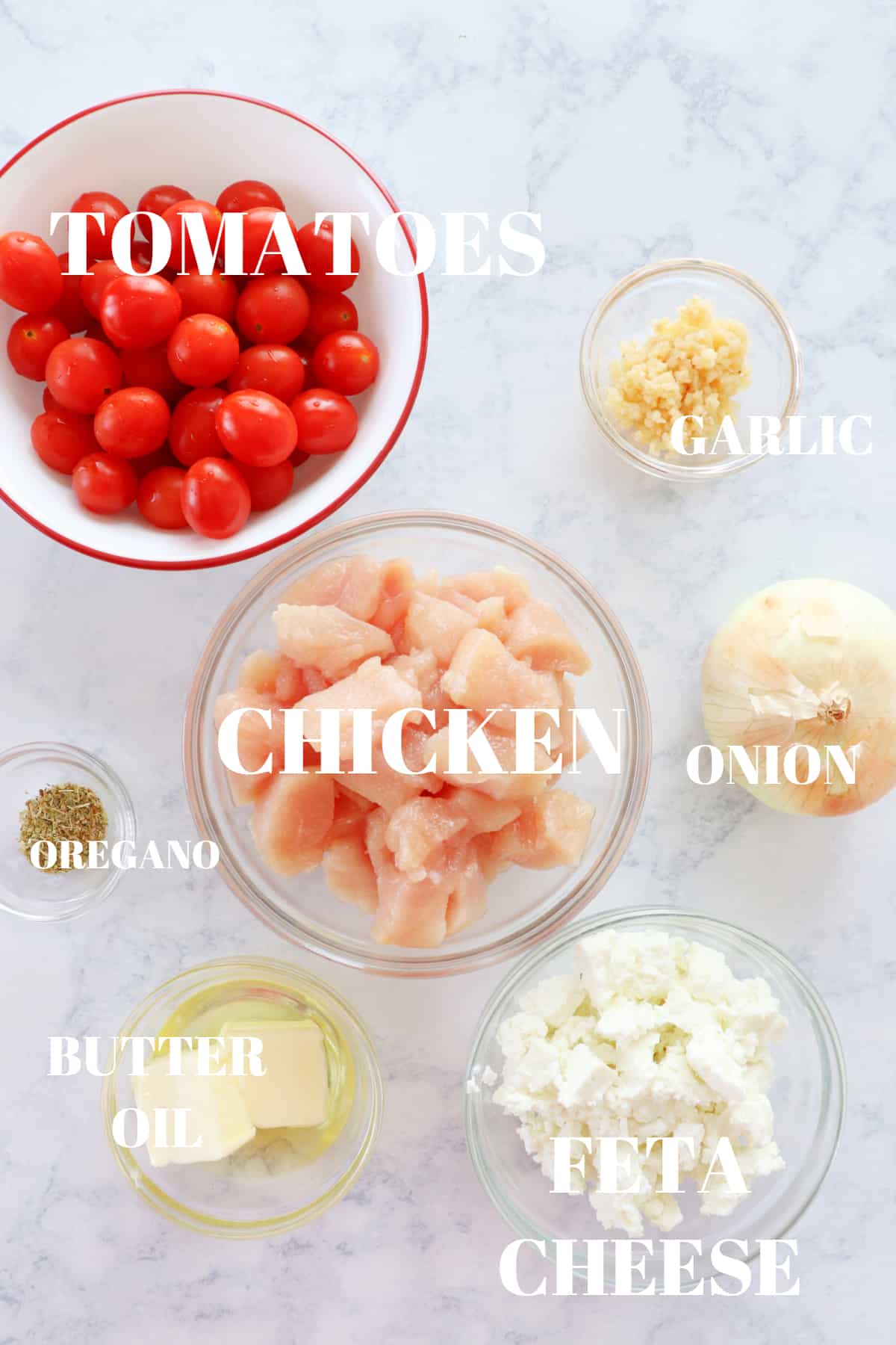 Ingredients for chicken skillet on a marble board.