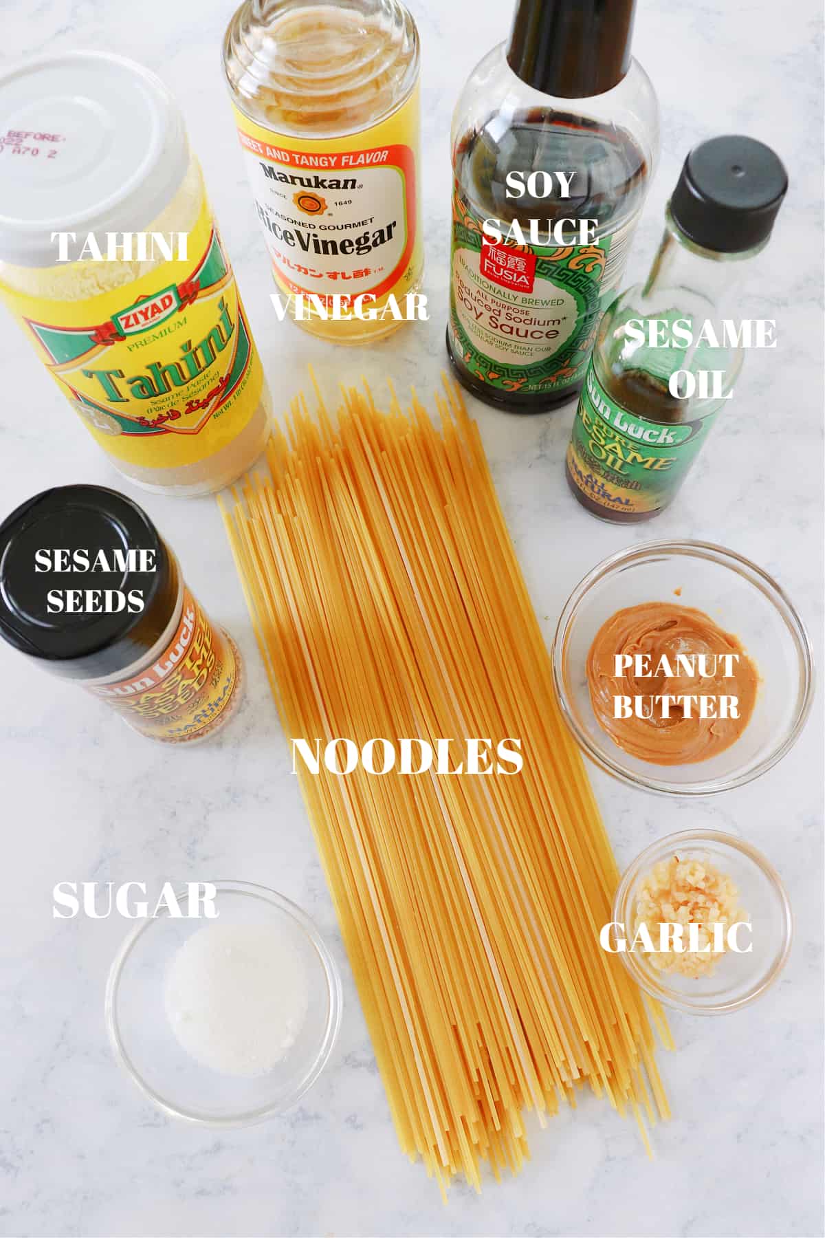 Ingredients for sesame noodles on a marble board.