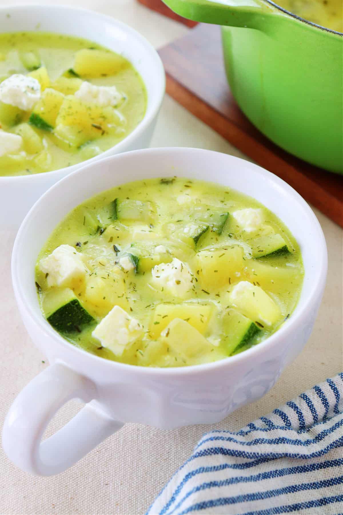 Soup with zucchini in two bowls.