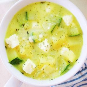 Zucchini soup in white bowl.