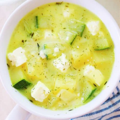 Zucchini soup in white bowl.