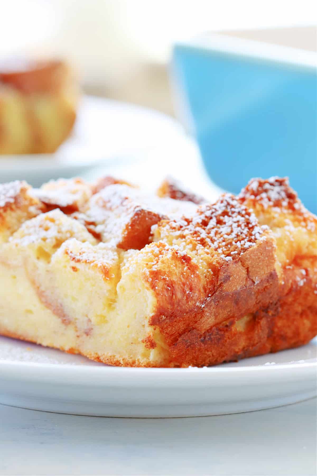 Close up shot of bread pudding slice on plate.