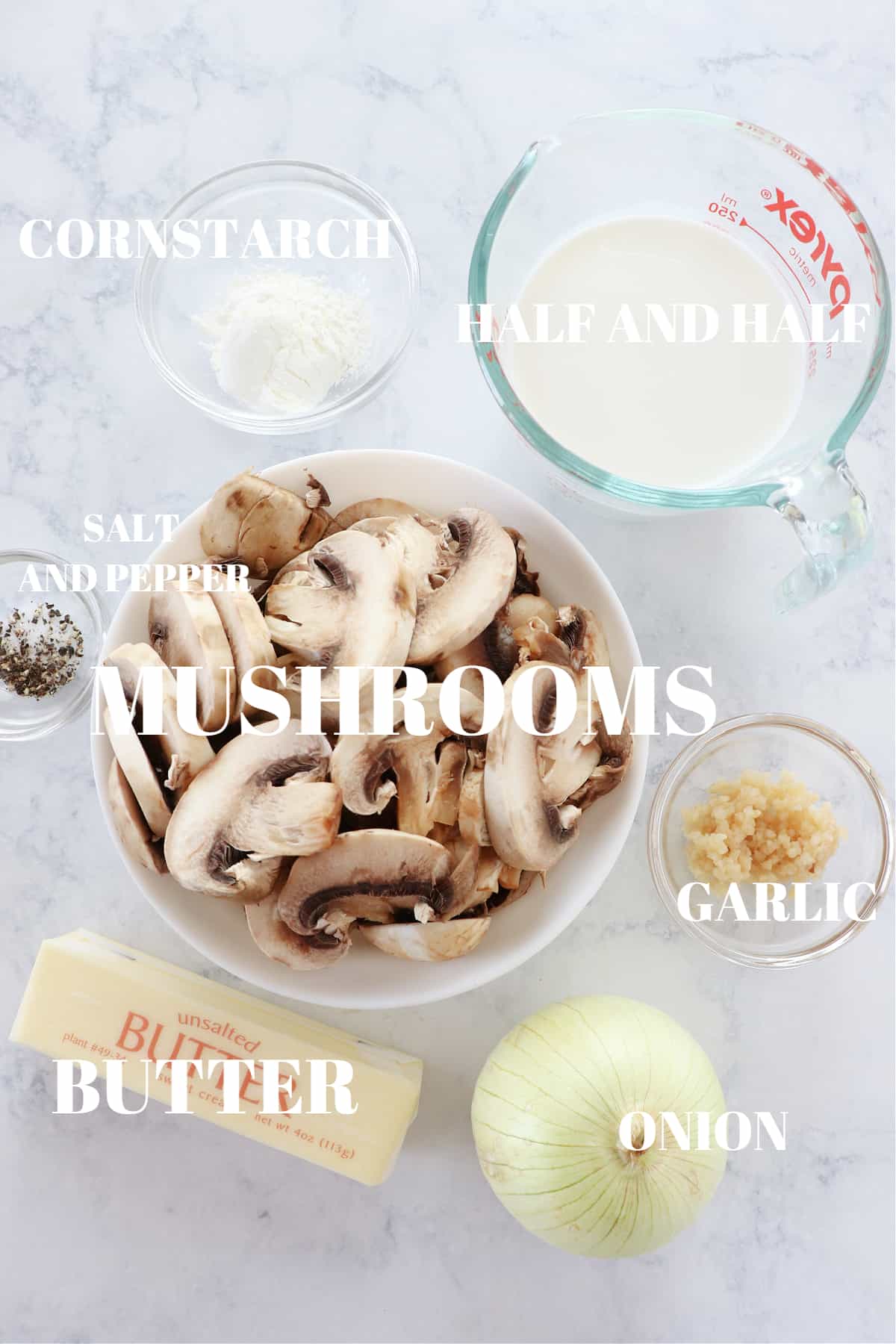 Ingredients for mushroom sauce on a marble board.