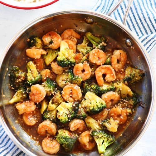 Shrimp, broccoli and stir fry sauce in a pan.