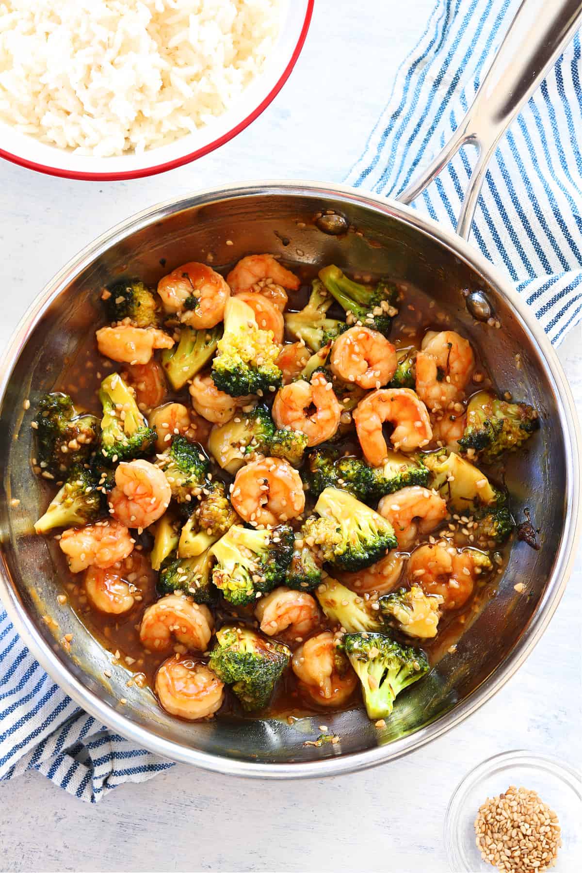 Shrimp, broccoli and stir fry sauce in a pan.