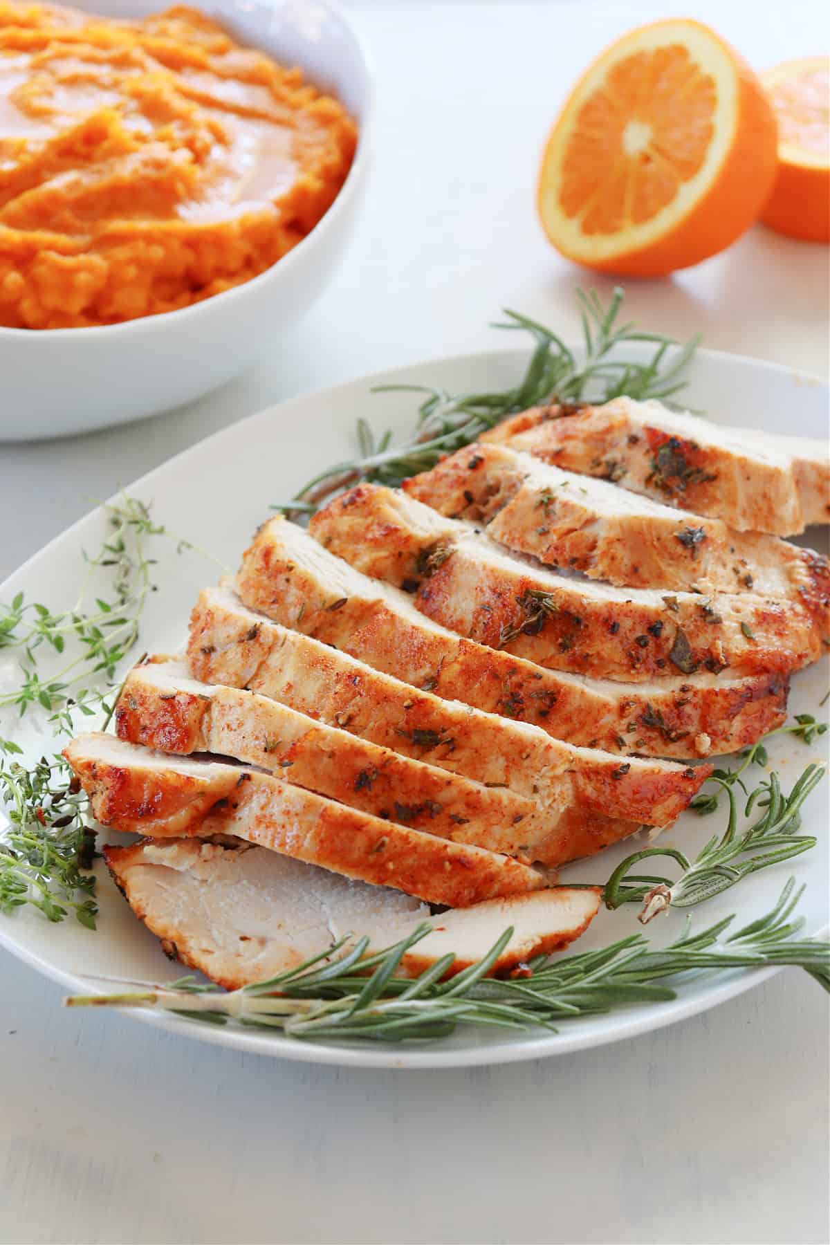 Air Fryer Turkey Breast recipe Turkey breast on a white plate.