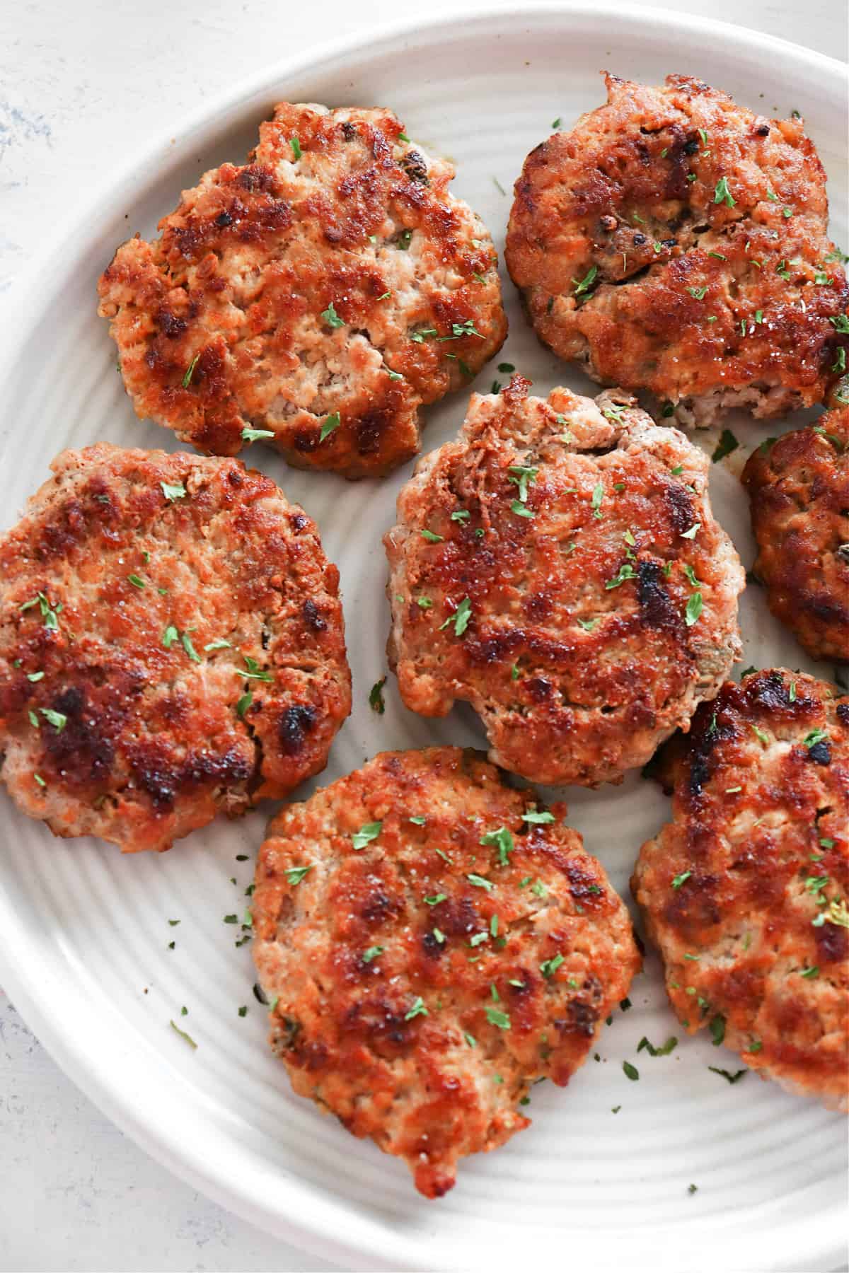 Breakfast sausage patties on a plate.