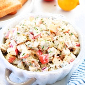 Turkey salad in a bowl on a board.