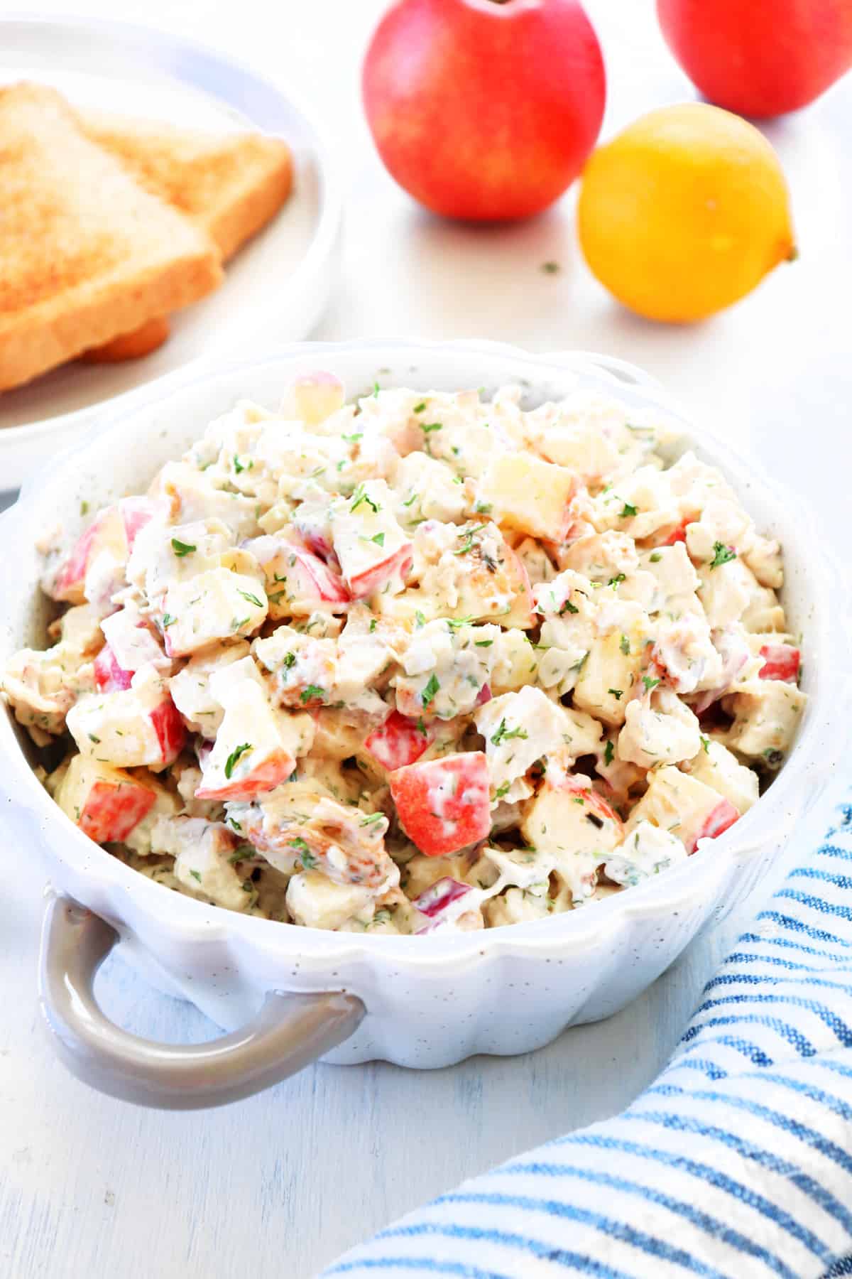 Leftover Turkey Salad recipe Turkey salad in a bowl on a board.