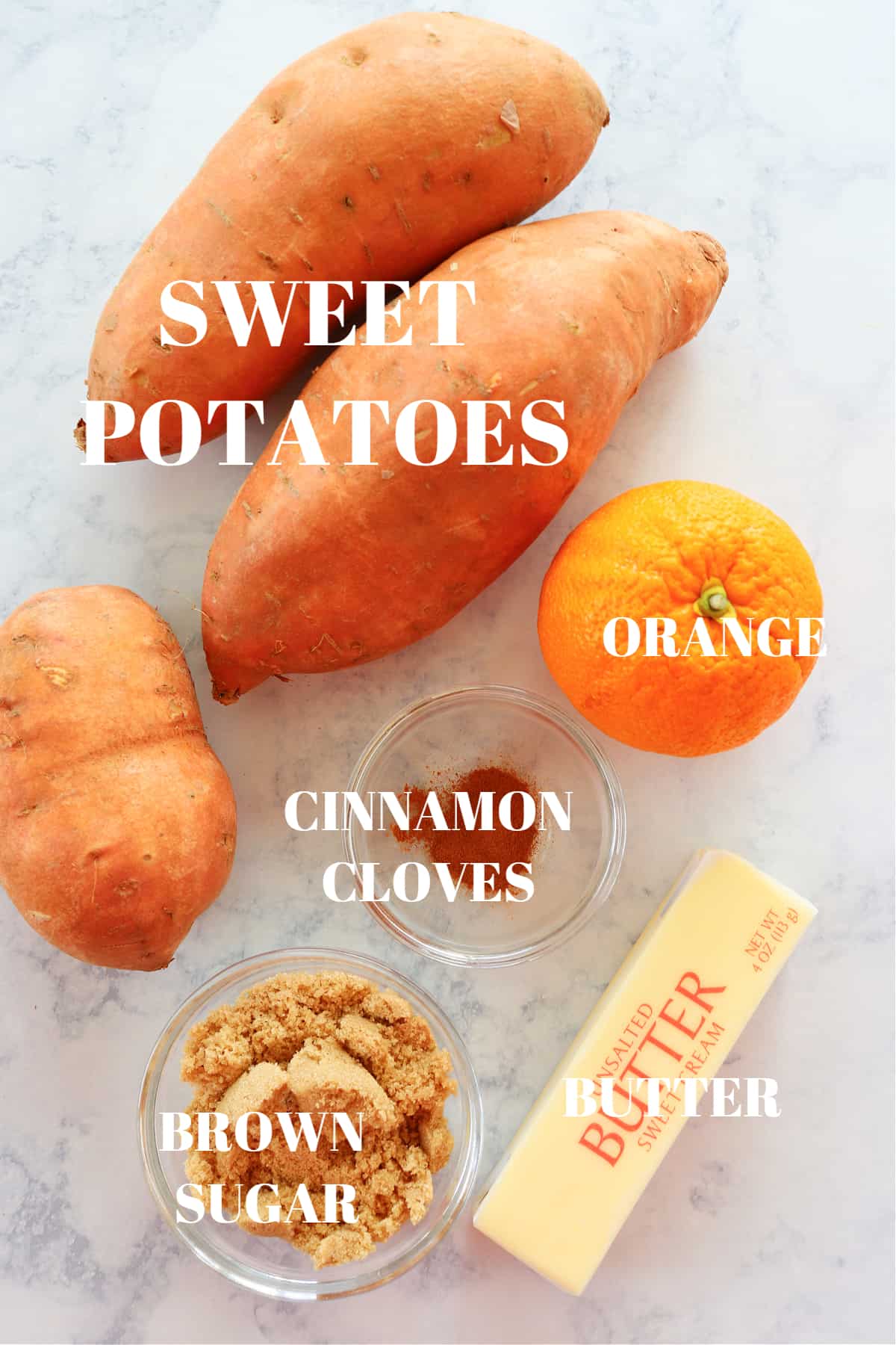 Ingredients for mashed sweet potatoes on a marble board.