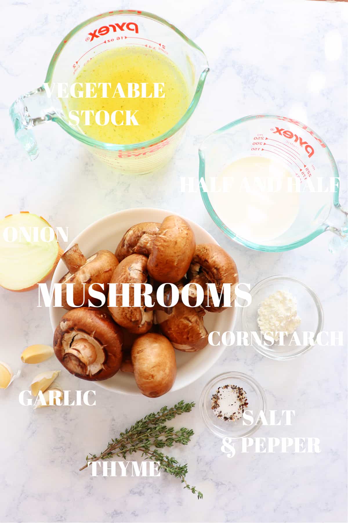 Ingredients for mushroom soup on a marble board.