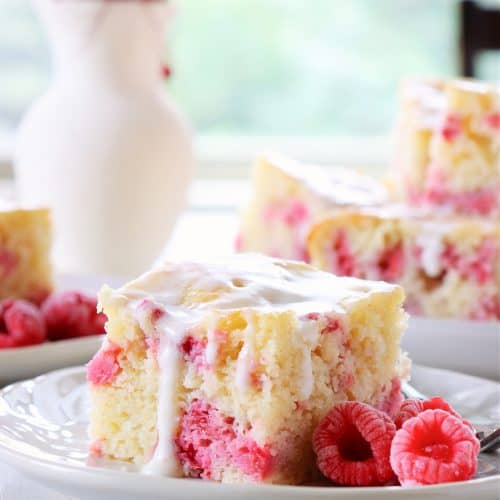 Slice of raspberry cake on a plate.