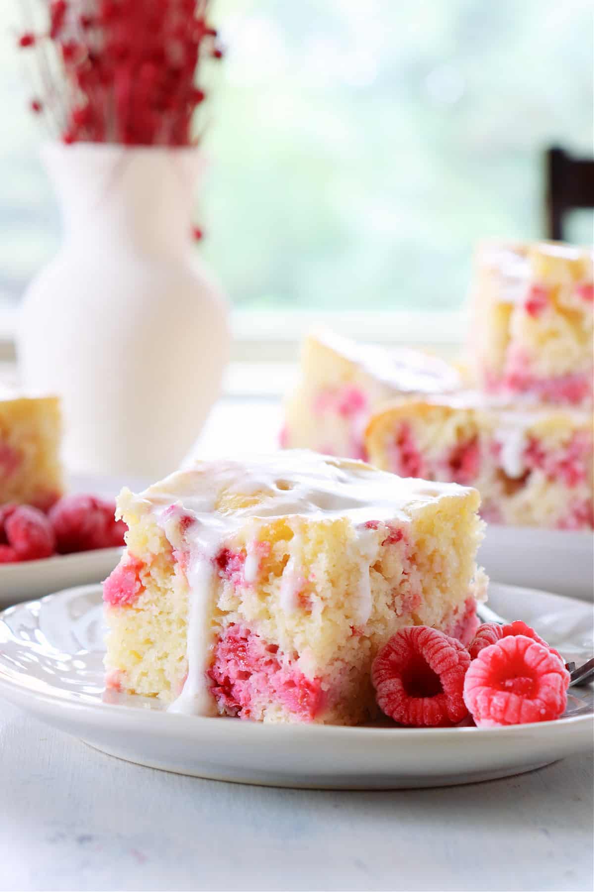 Slice of raspberry cake on a plate.