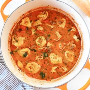 Tortellini soup with sausage in a Dutch oven.