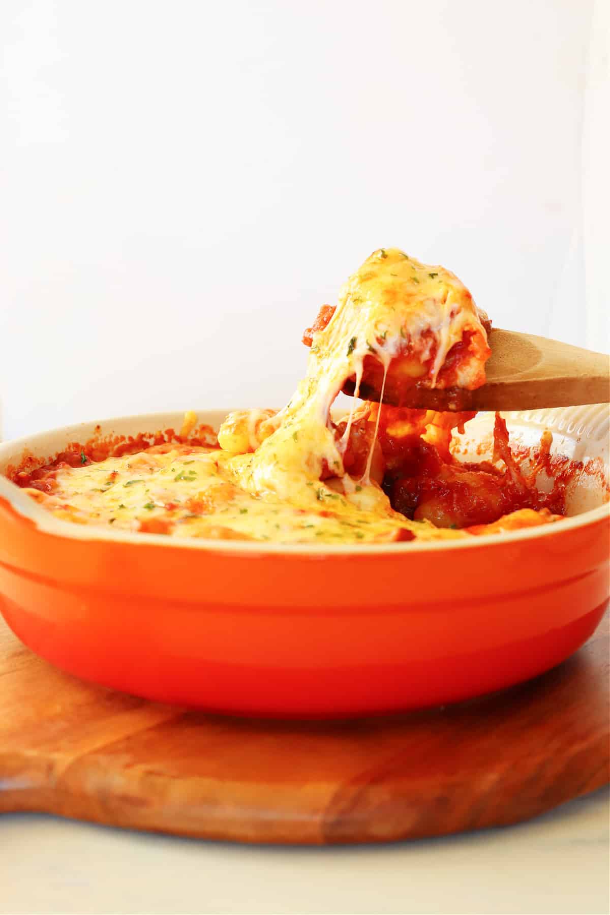 Cheesy top on gnocchi in baking dish.