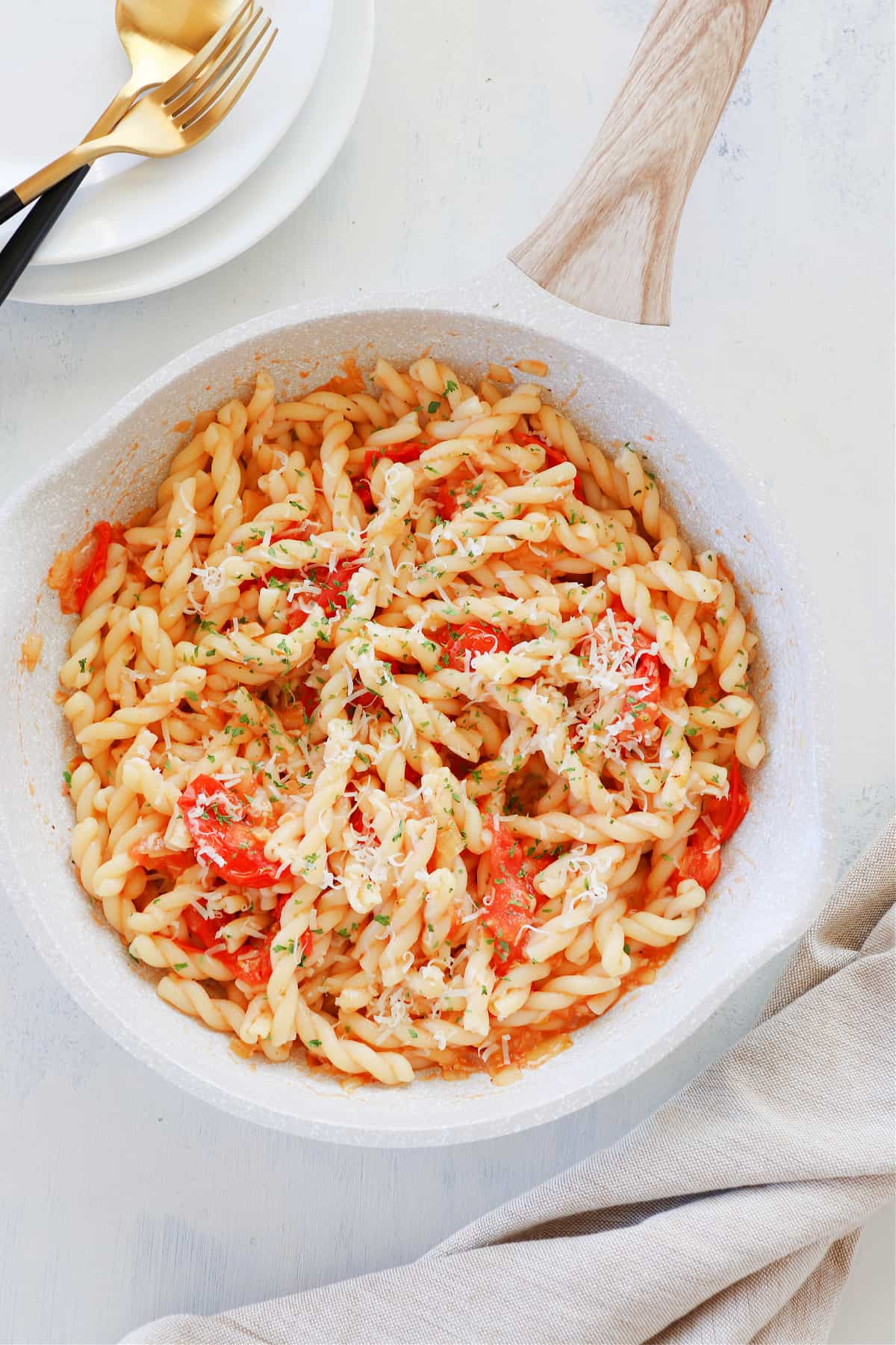 Pasta with tomatoes in a skillet.