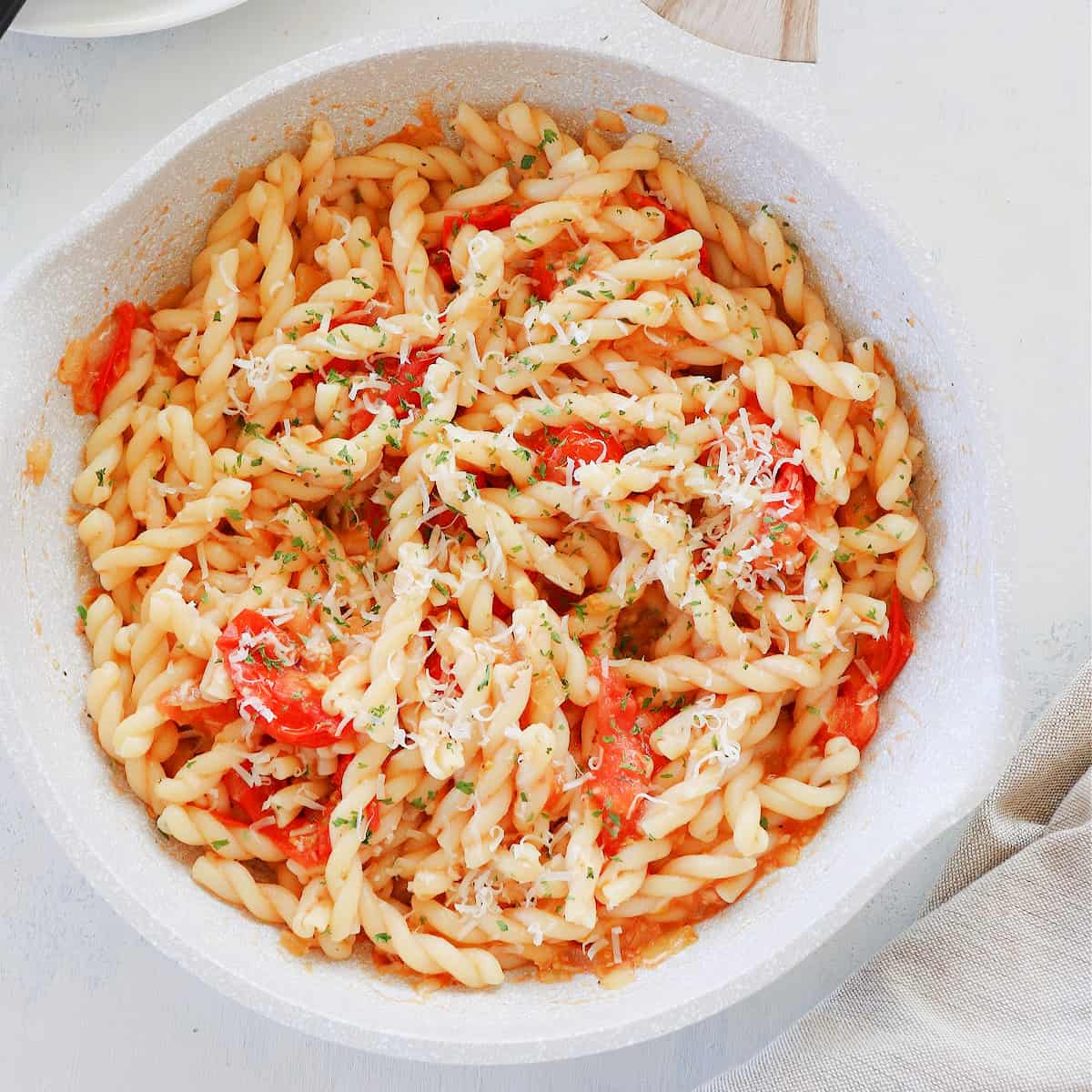 Pasta with tomatoes in a pan.