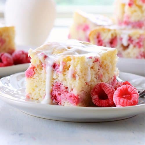 A slice of raspberry cake on a plate.