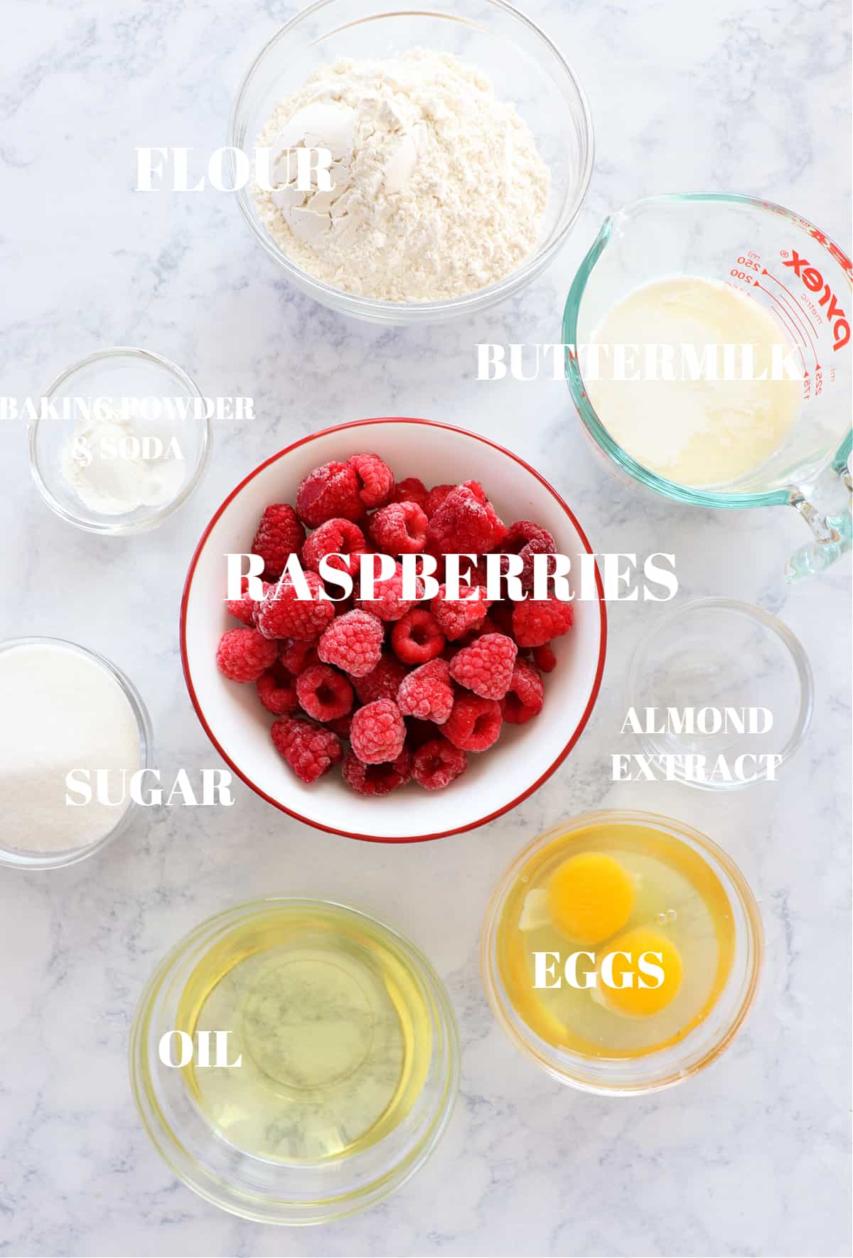 Ingredients for raspberry cake on a marble board.