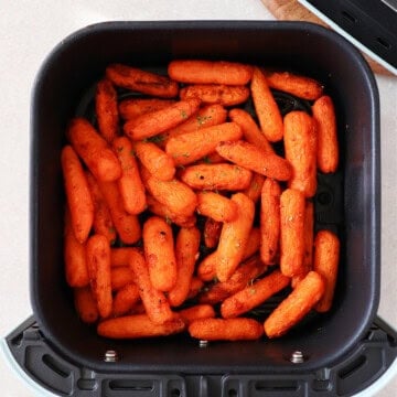 Baby carrots in the air fryer basket.
