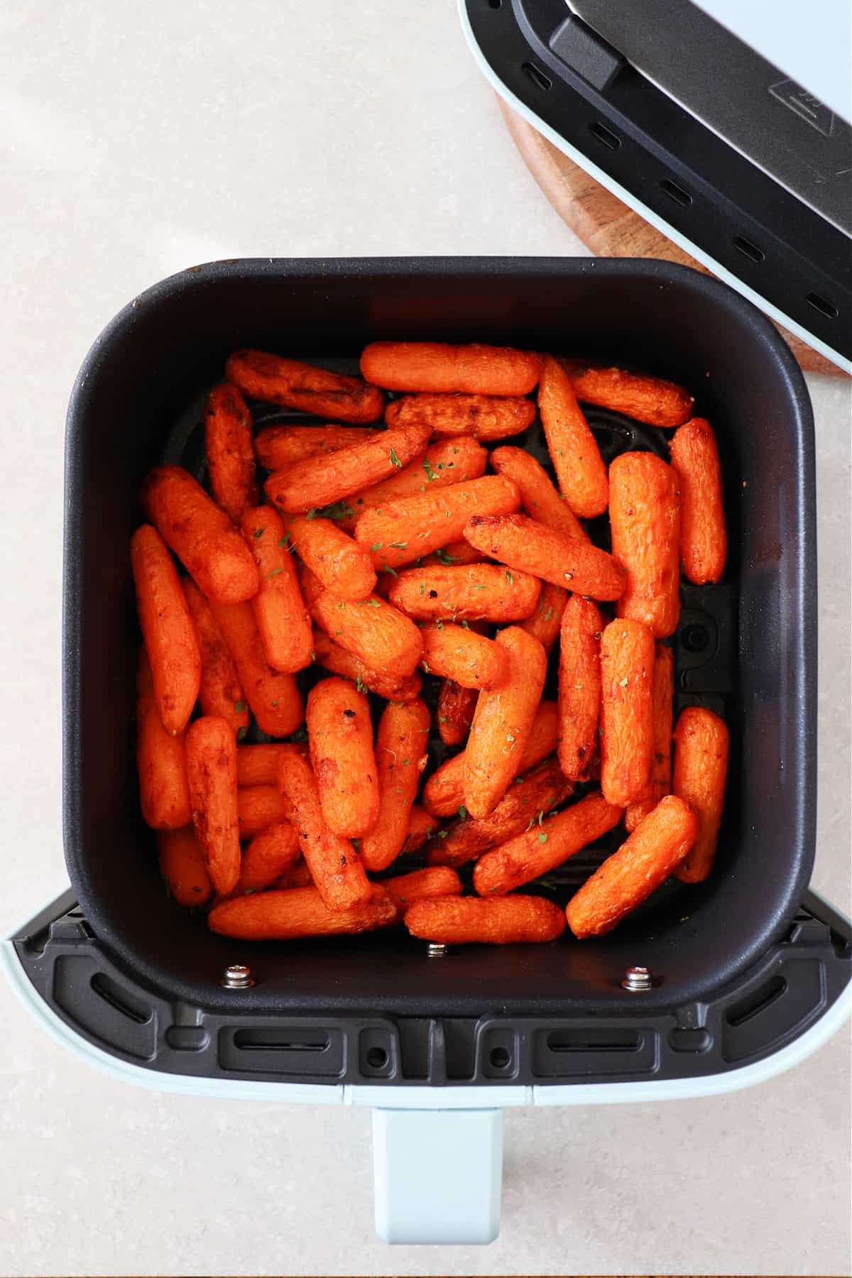 Air Fryer Carrots recipe Baby carrots in the air fryer basket.