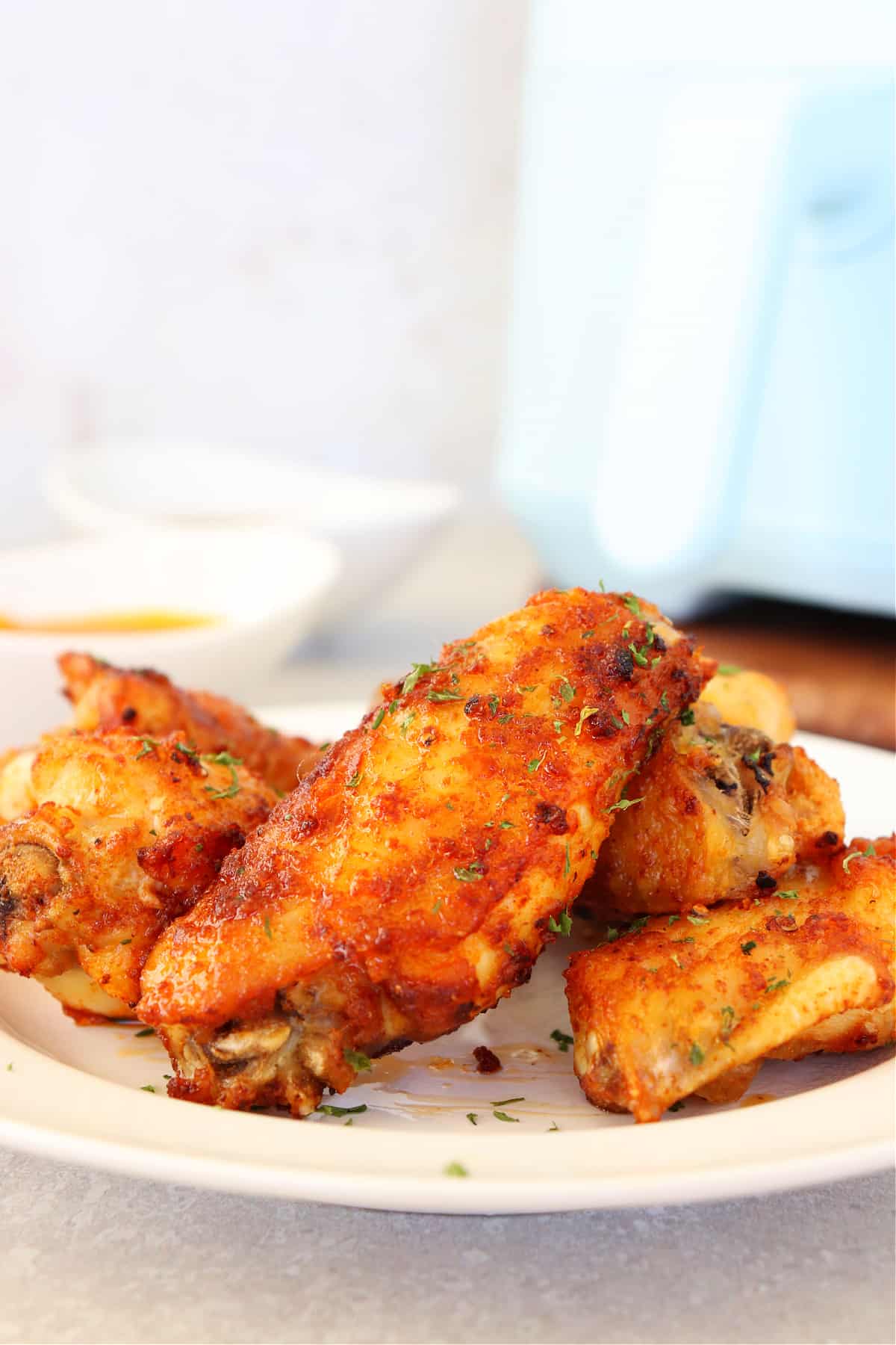 Close up on chicken wing on a plate.