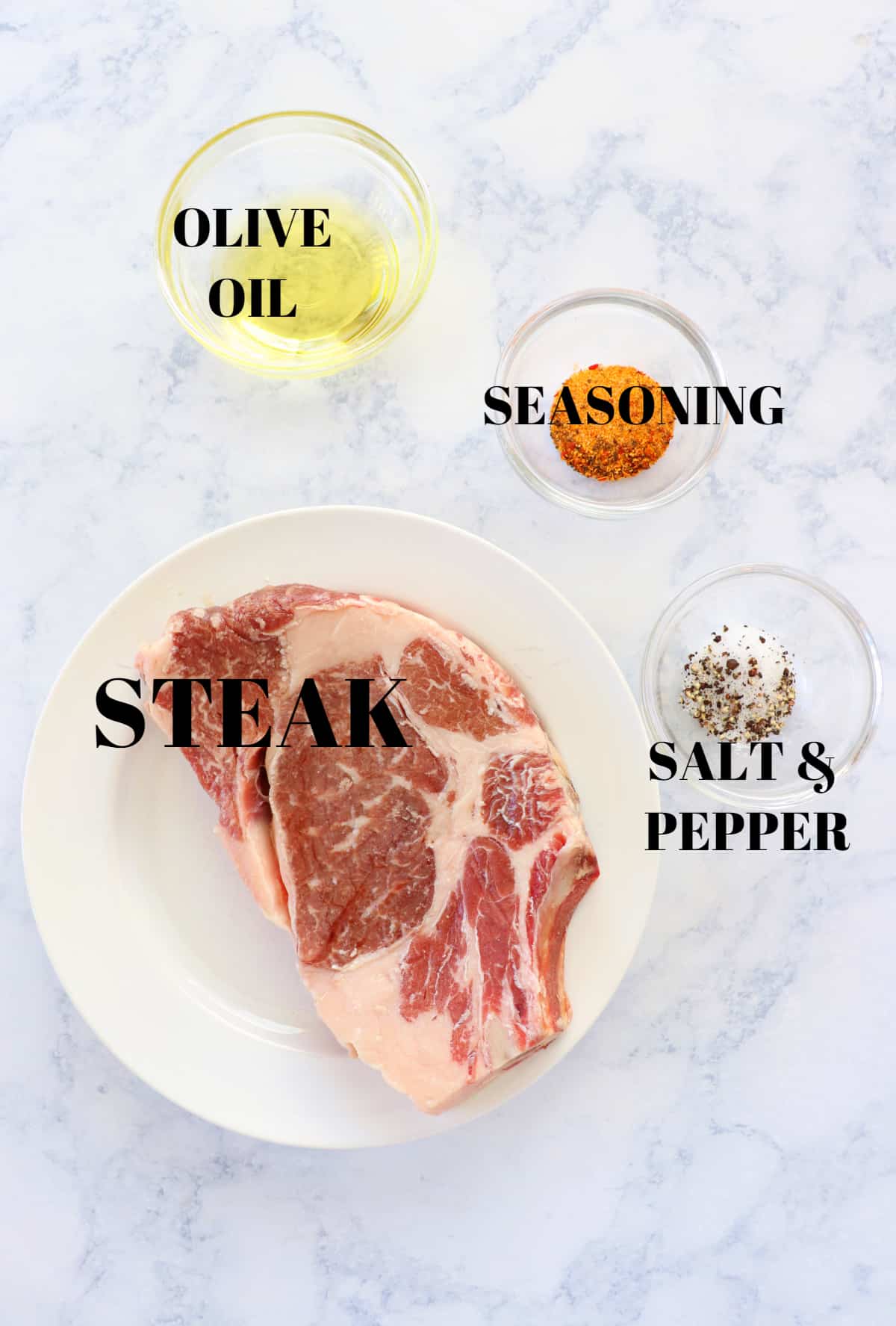 Ingredients for air fryer steak on a marble board.