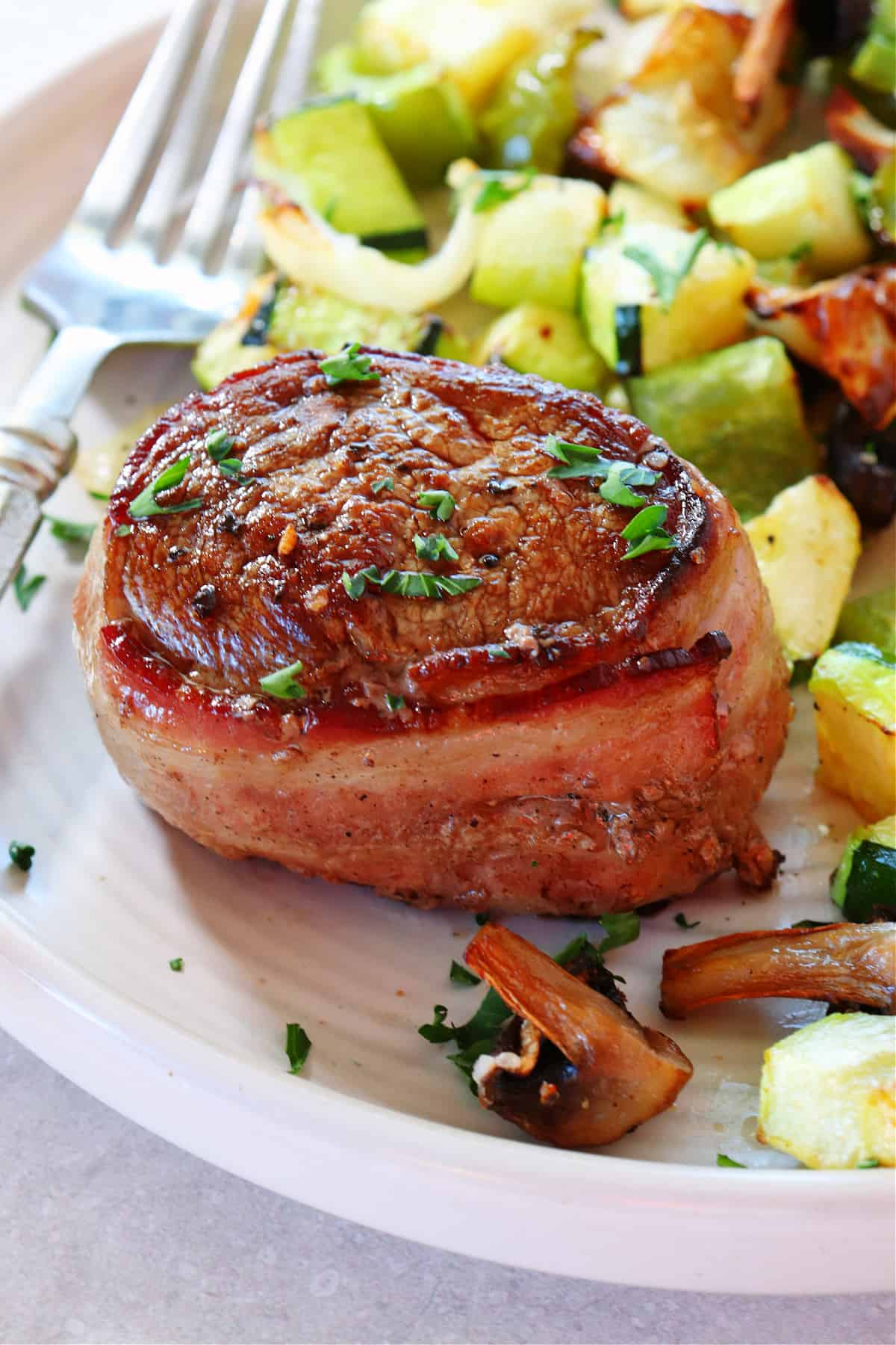 Filet mignon with vegetables on a plate.