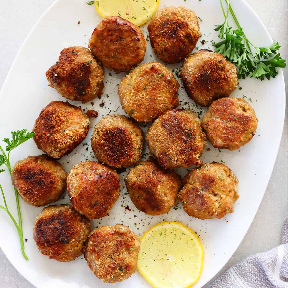 Turkey meatballs on a white oval plate.