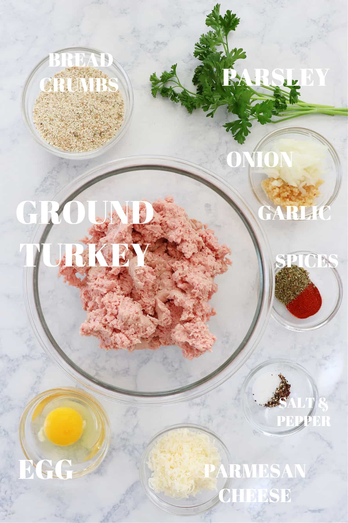Ingredients for turkey meatballs on a marble board.